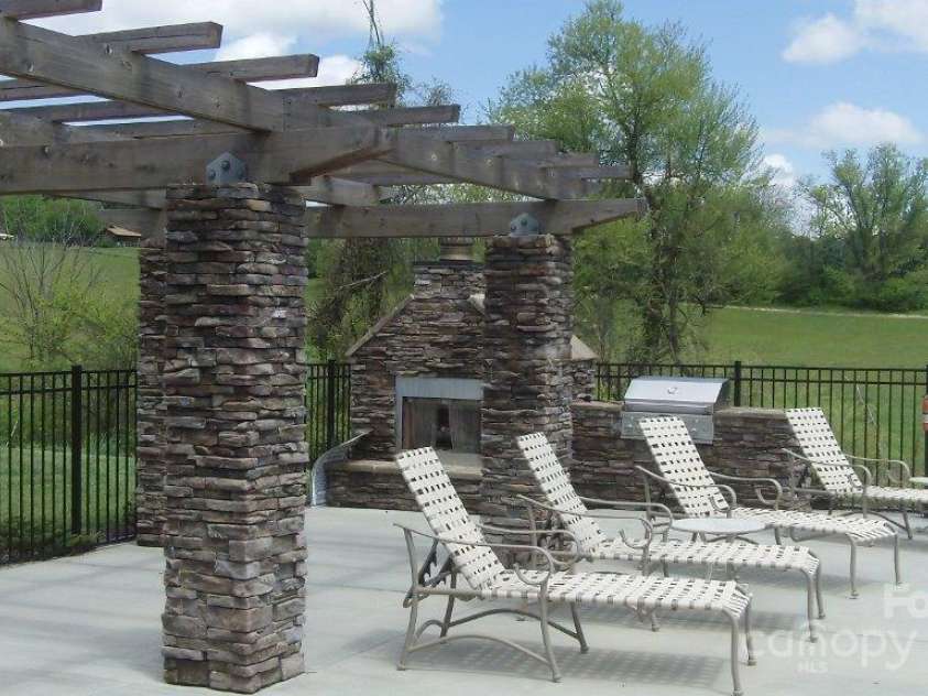 9999-S-3 Brookstone Place, Candler, NC 28715.  MLS# CAR4290047, YatesRealty ID 33063. Club house has pool with outside fireplace and grill