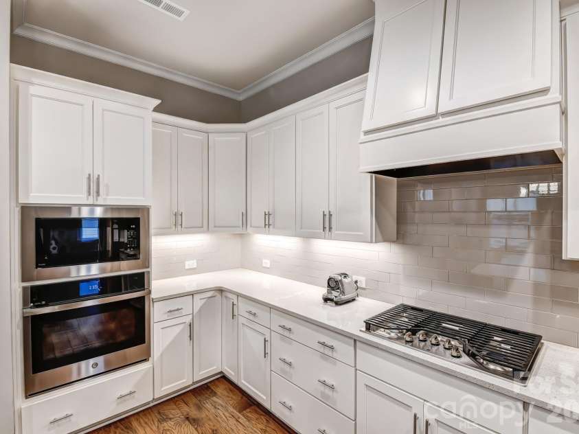3049 Alveston Drive, Concord, NC 28027.  MLS# CAR4396492, YatesRealty ID 33073. Tile backsplash, gas cook top, under cabinet lighting