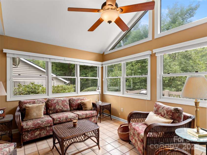25 Cedarcliff Circle, Asheville, NC 28803.  MLS# CAR4291336, YatesRealty ID 33090. The outdoors comes through to this sunroom