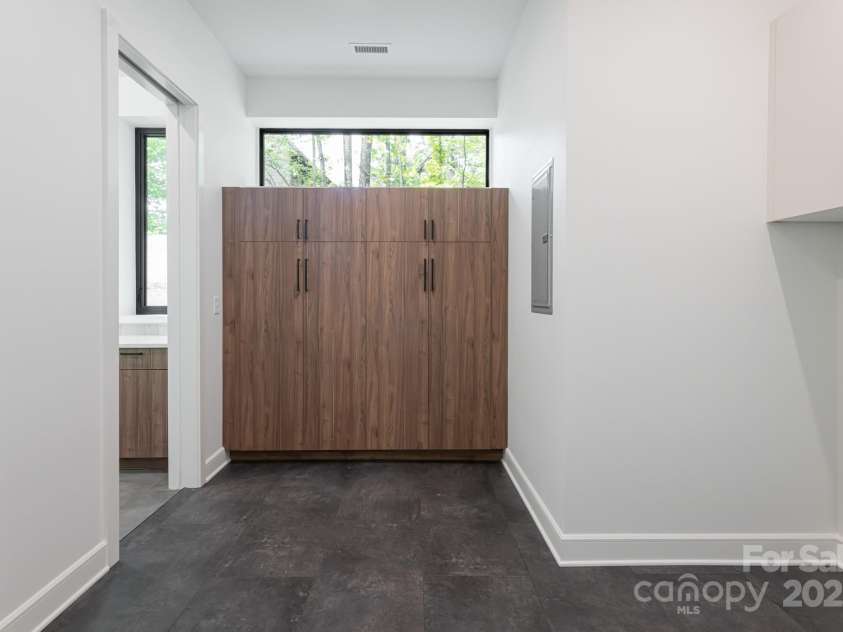 129 English Drive, Candler, NC 28715.  MLS# CAR4255359, YatesRealty ID 33098. Pantry + Laundry off Kitchen with Pocket Doors