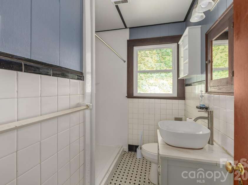 46 Gilkey Street, Marion, NC 28752.  MLS# CAR4396879, YatesRealty ID 33112. Bathroom in hallway between bedrooms.