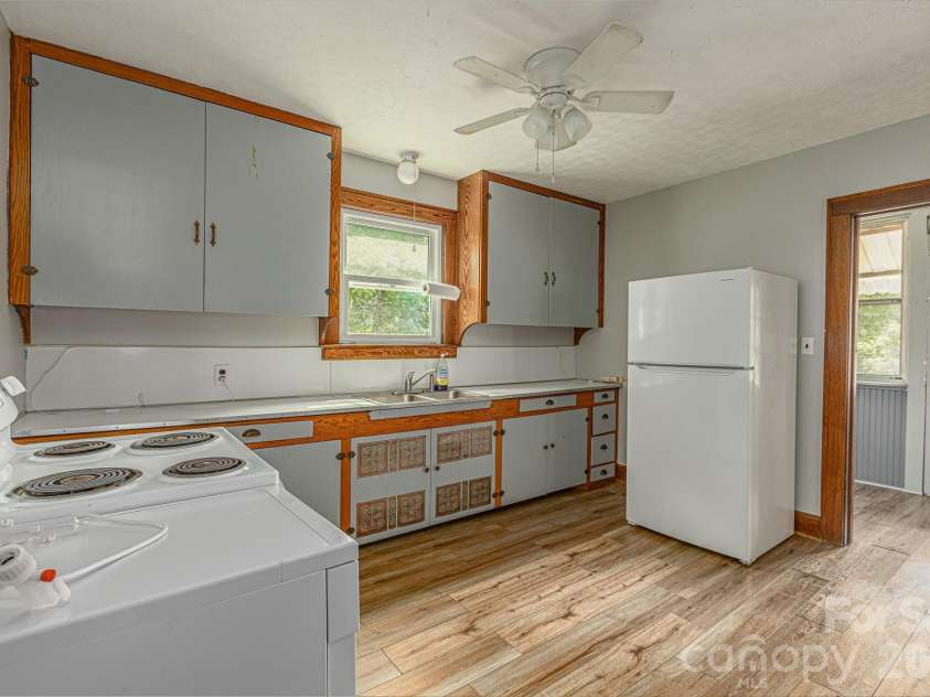 46 Gilkey Street, Marion, NC 28752.  MLS# CAR4396879, YatesRealty ID 33112. Kitchen looking into the sunroom.