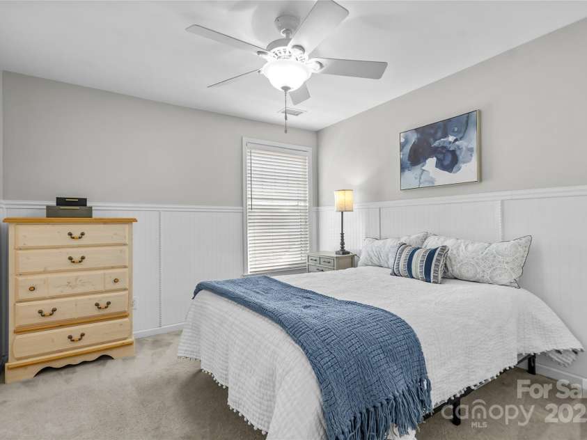 9724 Cadman Court, Cornelius, NC 28031.  MLS# CAR4233696, YatesRealty ID 3312. Bedroom 2 with beadboard accent paneling & ceiling fan/light!