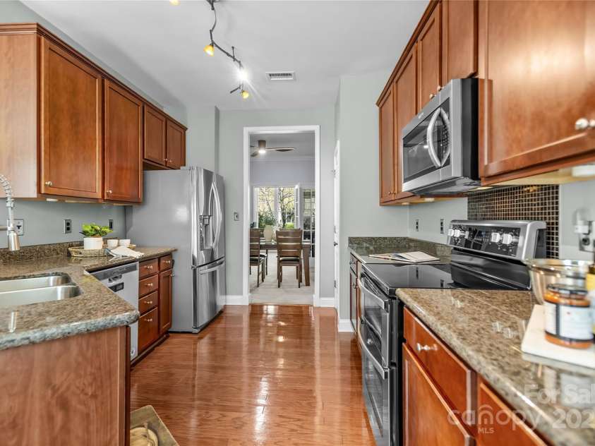 9724 Cadman Court, Cornelius, NC 28031.  MLS# CAR4233696, YatesRealty ID 3312. Kitchen with granite counters, stainless steel appliances, plenty of cabinets for storage, pantry & breakfast area!