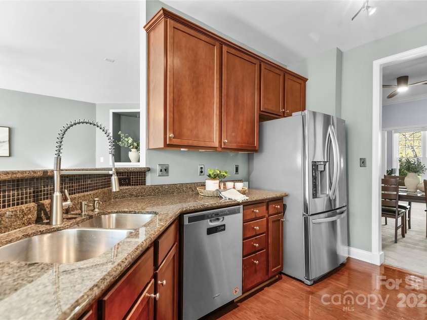 9724 Cadman Court, Cornelius, NC 28031.  MLS# CAR4233696, YatesRealty ID 3312. Kitchen with granite counters, stainless steel appliances, plenty of cabinets for storage, pantry & breakfast area!