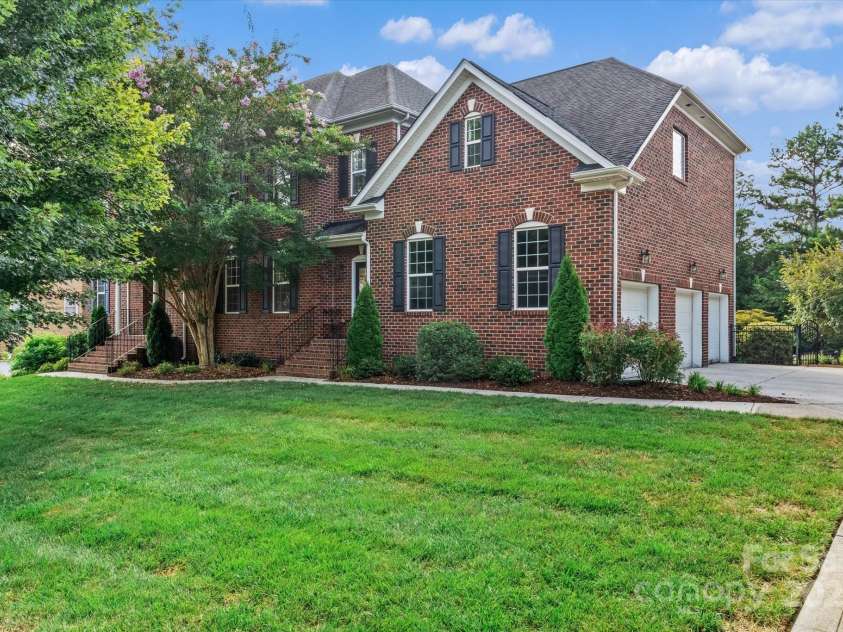 1040 Lake Forest Drive, Matthews, NC 28104.  MLS# CAR4285953, YatesRealty ID 33125. Exterior Front Right - 3 Car Garage