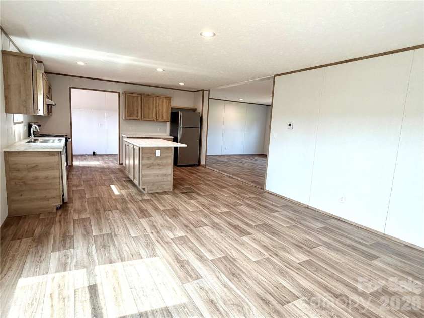 146 Con Lee Drive, Olin, NC 28660.  MLS# CAR4397827, YatesRealty ID 33129. FAMILY ROOM AND KITCHEN
