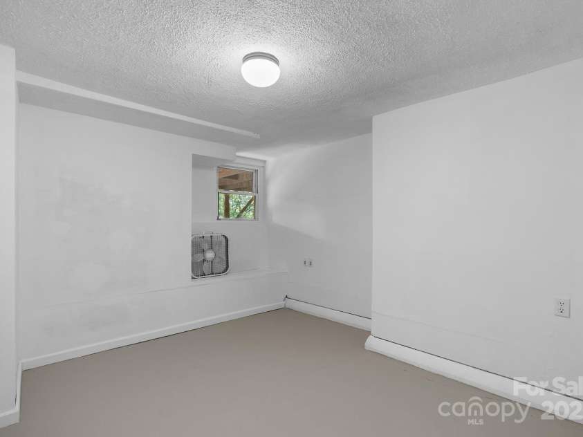 186 Pisgah View Road, Asheville, NC 28806.  MLS# CAR4293363, YatesRealty ID 33142. Lower level bedroom (no closet)