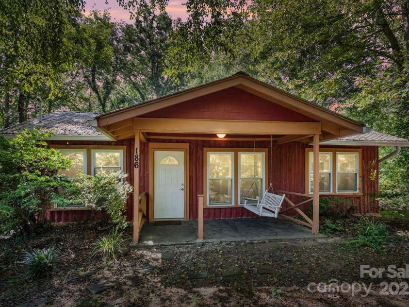 186 Pisgah View Road, Asheville, NC 28806.  MLS# CAR4293363, YatesRealty ID 33142. Rocking chair (or swing) front porch