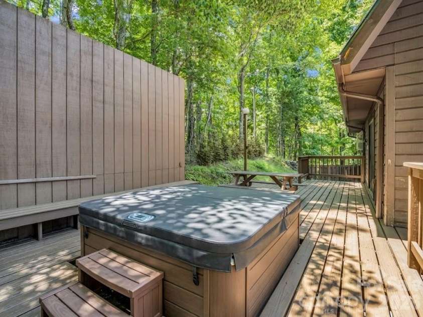 122 Birchwood Drive, Hendersonville, NC 28739.  MLS# CAR4397115, YatesRealty ID 33158. Hot tub virtually edited. Current one is non-functioning and has a tree growing out of it