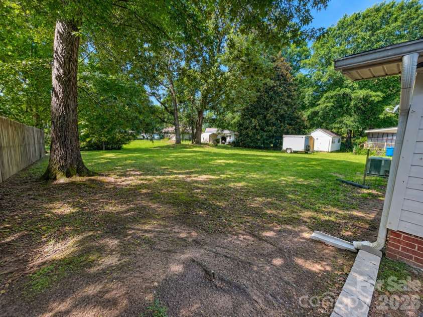203 Danita Drive, Locust, NC 28097.  MLS# CAR4393303, YatesRealty ID 33174. Open backyard .36+/- acres.