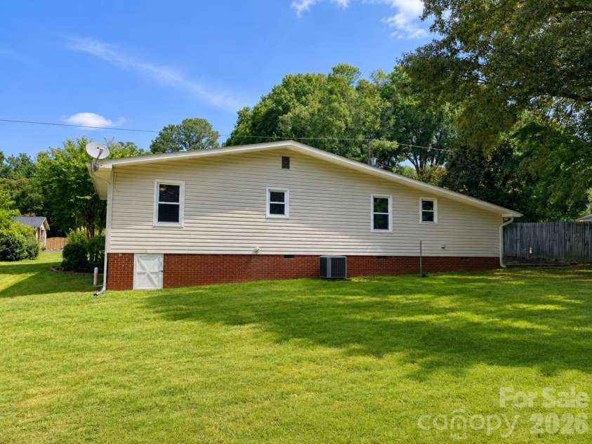 203 Danita Drive, Locust, NC 28097.  MLS# CAR4393303, YatesRealty ID 33174. Open backyard for endless possibilities.