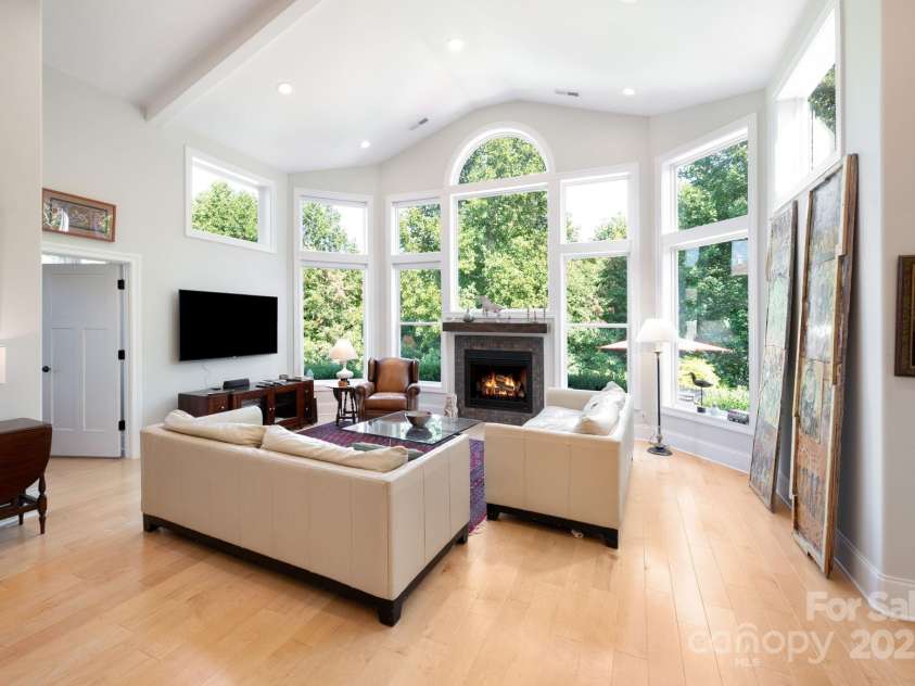 33 Penley Park Drive, Weaverville, NC 28787.  MLS# CAR4286490, YatesRealty ID 33176. Bright and comfortable, the living space offers a gas fireplace and a stunning wall of windows that fills the room with natural light.