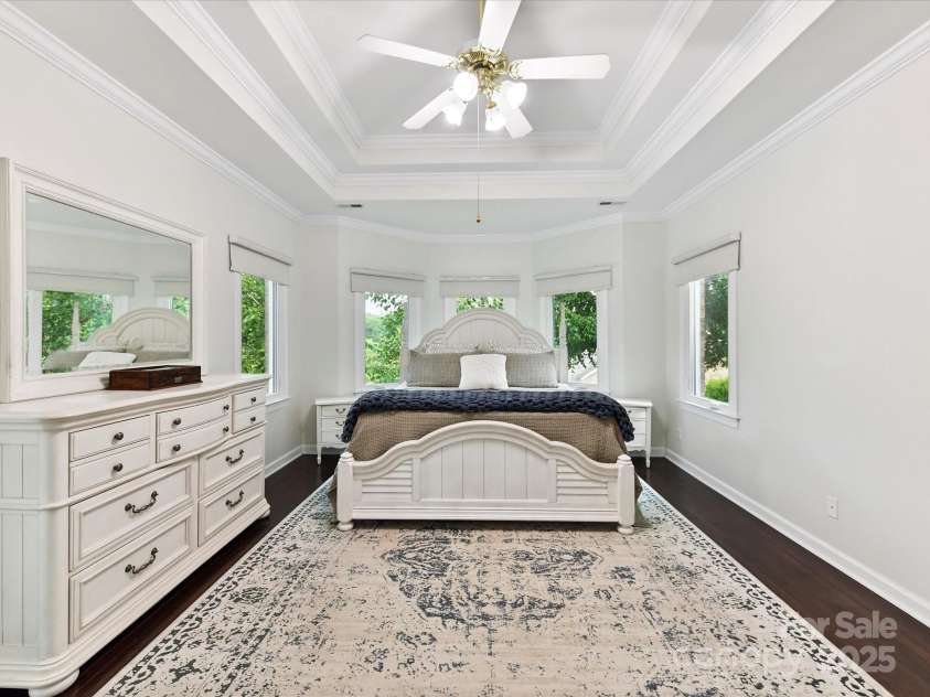 4032 Cambridge Hill Lane, Charlotte, NC 28270.  MLS# CAR4277573, YatesRealty ID 33179. A spacious primary bedroom features a tray ceiling & double doors.
