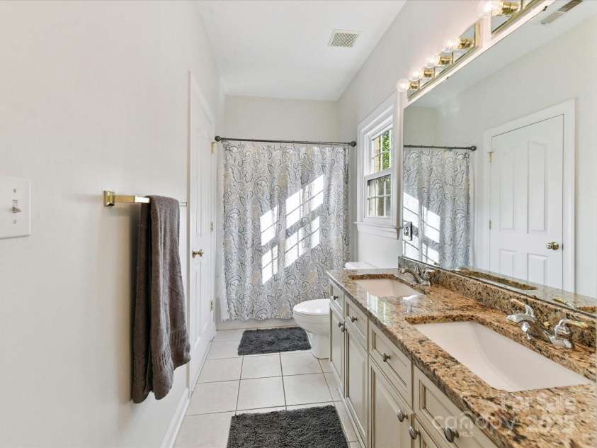4032 Cambridge Hill Lane, Charlotte, NC 28270.  MLS# CAR4277573, YatesRealty ID 33179. A wonderful Jack & Jill bathroom features dual vanities and a shower/tub!
