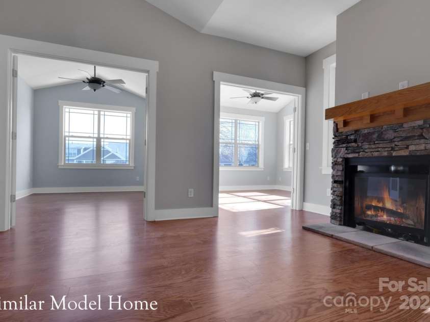 24-#S-4 Brookstone Place, Candler, NC 28715.  MLS# CAR4289931, YatesRealty ID 33190. Airy, vaulted living room with fireplace for warmth and charm