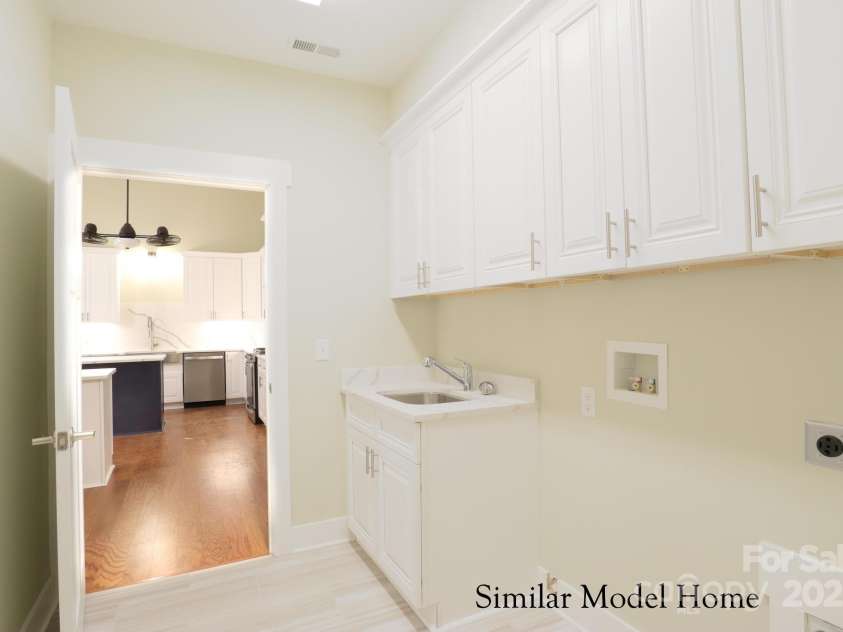 24-#S-4 Brookstone Place, Candler, NC 28715.  MLS# CAR4289931, YatesRealty ID 33190. Spacious laundry room with Abundant storage for easy organization