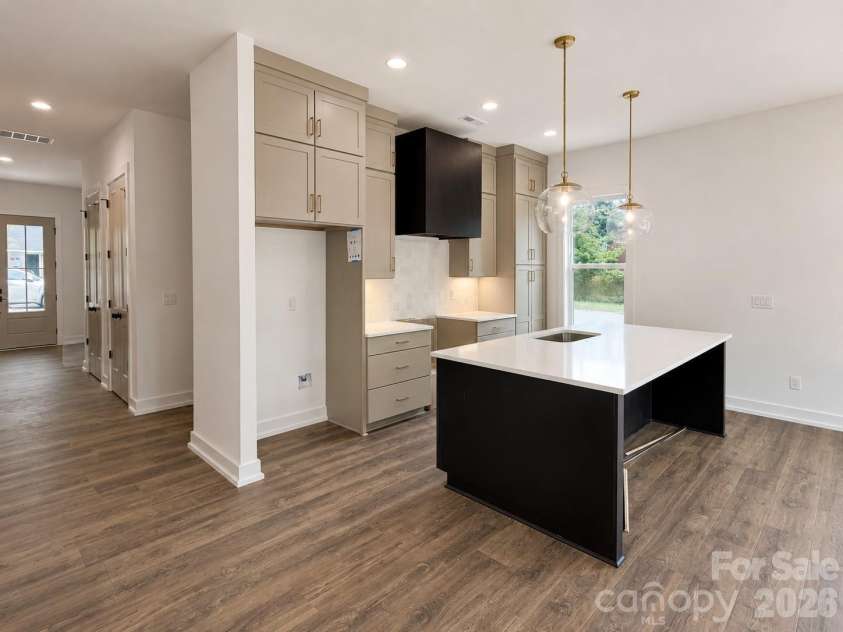 3926 Sarah Drive, Charlotte, NC 28217.  MLS# CAR4334523, YatesRealty ID 33198. Curated kitchen-stacked kitchen cabinets to the 10ft ceiling, Quartz countertop and linear range hood.