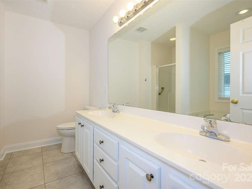 12617 Hill Pine Road, Midland, NC 28107.  MLS# CAR4291136, YatesRealty ID 33201. Dual sink vanity, tile flooring.  Ample storage space in thie primary bath.