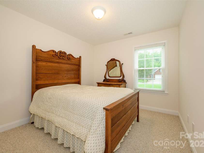 12617 Hill Pine Road, Midland, NC 28107.  MLS# CAR4291136, YatesRealty ID 33201. The first of two bedrooms with Berber carpeting and 2