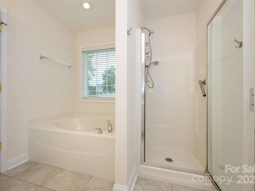 12617 Hill Pine Road, Midland, NC 28107.  MLS# CAR4291136, YatesRealty ID 33201. This primary bath also features a garden tub with a wonderful view of the back yard and a stand up shower.