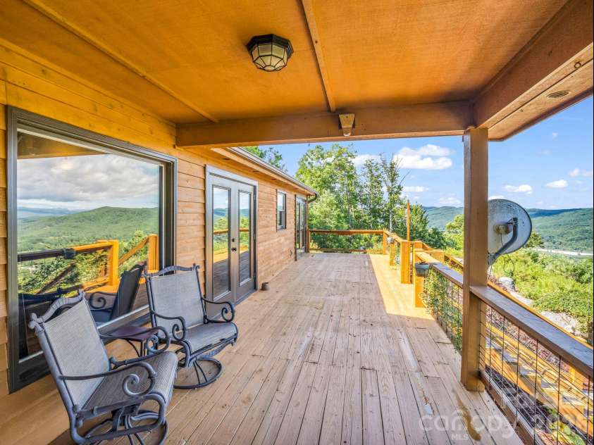 1025 Jeter Mountain Road, Penrose, NC 28766.  MLS# CAR4397105, YatesRealty ID 33202. Approx 600 sf deck with 1/2 covered 1/2 open