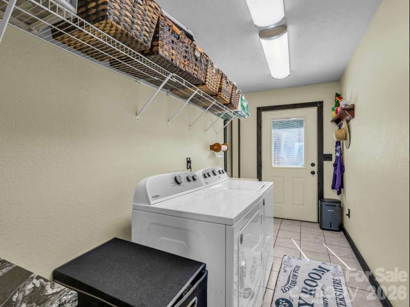 1025 Jeter Mountain Road, Penrose, NC 28766.  MLS# CAR4397105, YatesRealty ID 33202. Laundry room (back door)