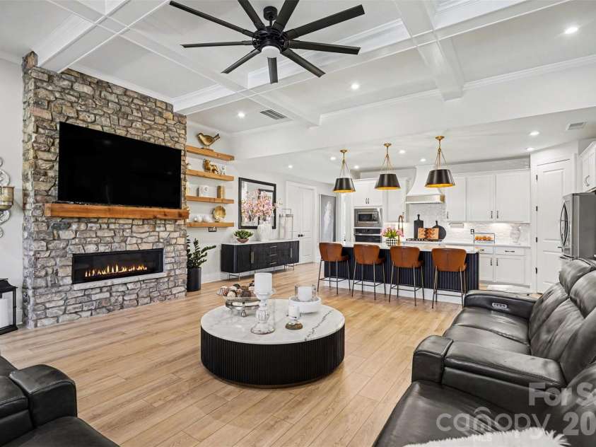8027 Longwaters Court, York, SC 29745.  MLS# CAR4426129, YatesRealty ID 33228. Open living, kitchen, and dining under a coffered ceiling.