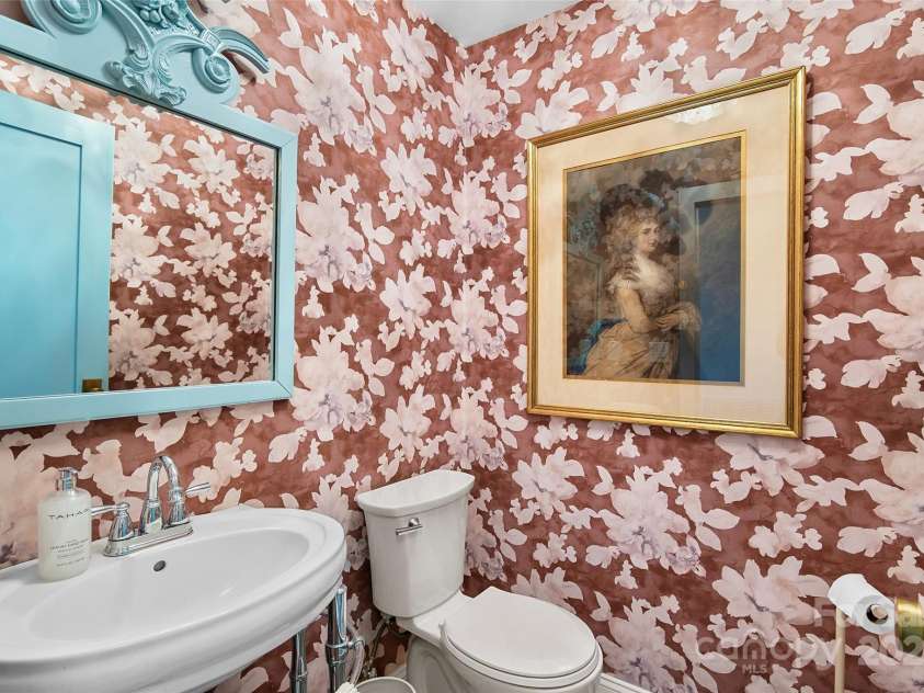 112 Pearson Drive, Asheville, NC 28801.  MLS# CAR4322267, YatesRealty ID 3323. A convenient half bath sits off the central hallway leading to the spacious, private primary suite.