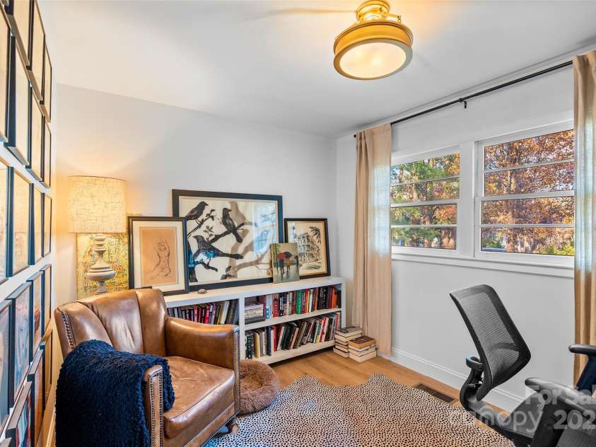 112 Pearson Drive, Asheville, NC 28801.  MLS# CAR4322267, YatesRealty ID 3323. Bright and versatile, this front room—currently used as an office—works beautifully as a guest room, dining room, library, music room and more!