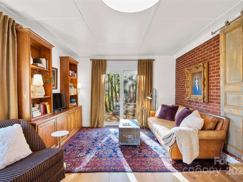 112 Pearson Drive, Asheville, NC 28801.  MLS# CAR4322267, YatesRealty ID 3323. Elegant, oversized sliding French doors enhance the style and versatility of this stylish brick ranch family room.