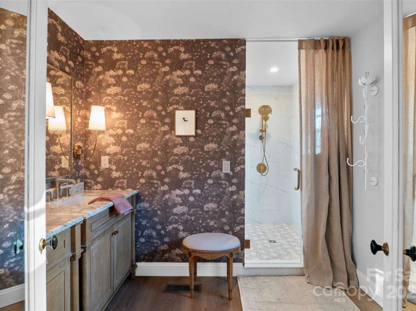 112 Pearson Drive, Asheville, NC 28801.  MLS# CAR4322267, YatesRealty ID 3323. Option 1 — Polished & conciseDouble sinks and a spacious custom-tiled shower with a glass door make the primary suite bath feel both luxurious and practical.