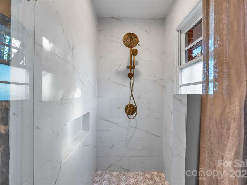 112 Pearson Drive, Asheville, NC 28801.  MLS# CAR4322267, YatesRealty ID 3323. Refresh and revive in this custom-tiled shower designed for everyday relaxation.