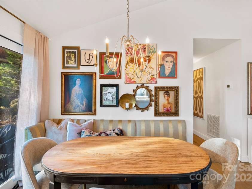 112 Pearson Drive, Asheville, NC 28801.  MLS# CAR4322267, YatesRealty ID 3323. This gracious dining area exudes warmth and elegance, creating a space where you’ll feel right at home.