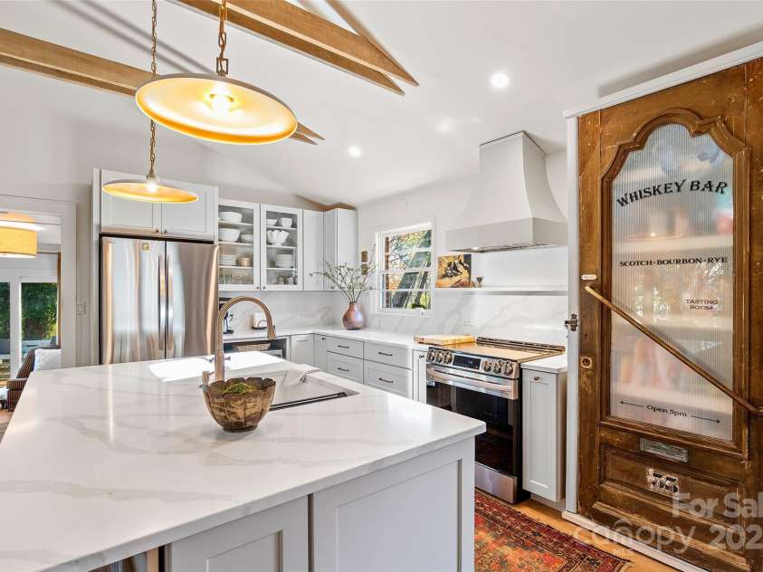 112 Pearson Drive, Asheville, NC 28801.  MLS# CAR4322267, YatesRealty ID 3323. This unique, exceptionally designed home makes you feel on vacation—whiskey pantry included. Drinks, anyone?