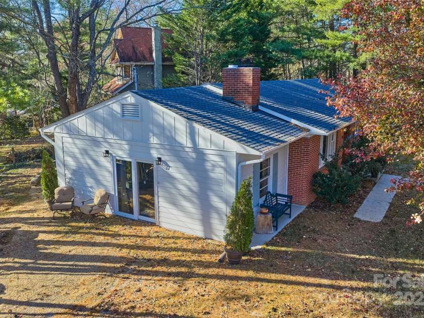 112 Pearson Drive, Asheville, NC 28801.  MLS# CAR4322267, YatesRealty ID 3323. View of the side of the home an side yard near the corner.  
