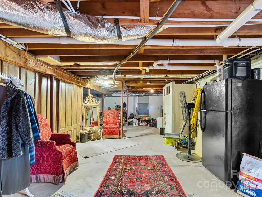 112 Pearson Drive, Asheville, NC 28801.  MLS# CAR4322267, YatesRealty ID 3323. With a toilet already in place, this spacious unfinished basement offers the perfect spot for a future full bath.