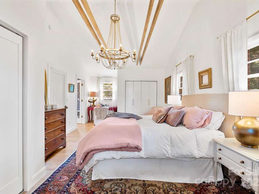 112 Pearson Drive, Asheville, NC 28801.  MLS# CAR4322267, YatesRealty ID 3323. With dual closets, a dressing table niche, and a welcoming sitting area, this primary suite offers comfort and convenience in every corner.