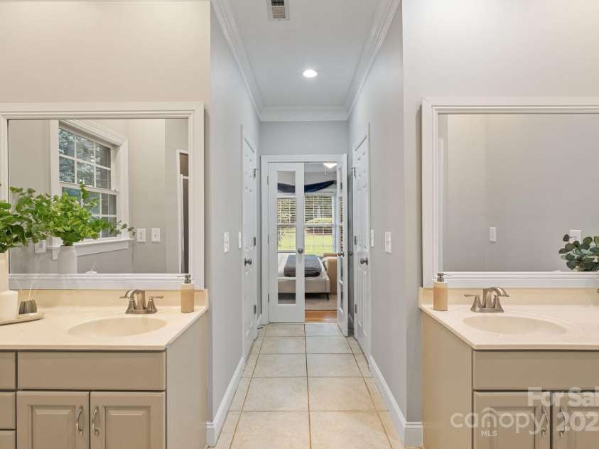 501 Colonels Court, Clover, SC 29710.  MLS# CAR4288032, YatesRealty ID 33243. The primary bathroom has dual sink vanities and 2 walk in closets