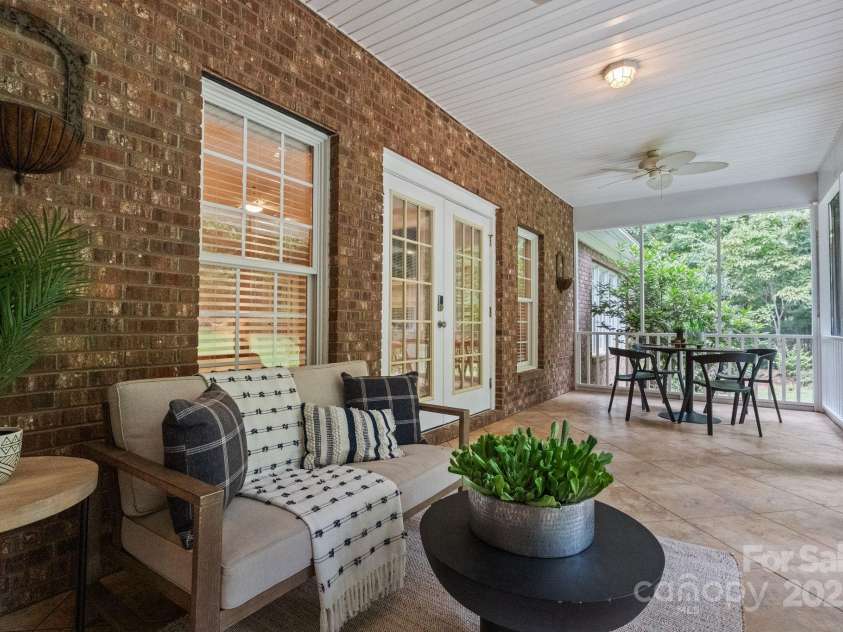 501 Colonels Court, Clover, SC 29710.  MLS# CAR4288032, YatesRealty ID 33243. Your peaceful back porch, fully screened in- looking out over the backyard towards the pool