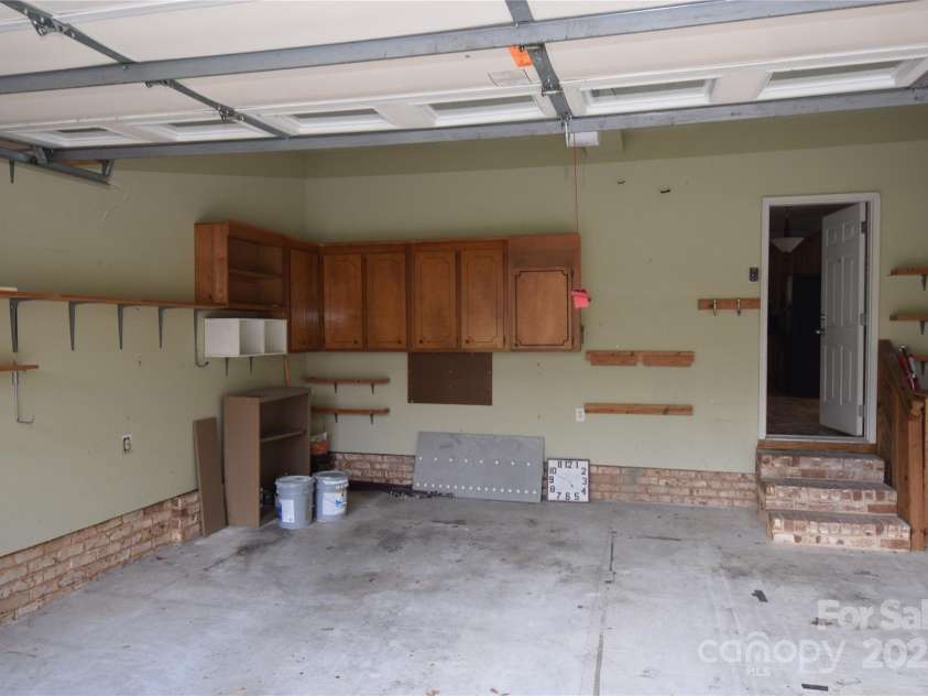 809 Pine Forest Road, Charlotte, NC 28214.  MLS# CAR4203407, YatesRealty ID 3326. Large garage with storage cabinet.