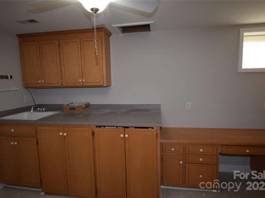 809 Pine Forest Road, Charlotte, NC 28214.  MLS# CAR4203407, YatesRealty ID 3326. Laundry room with sink and desk .