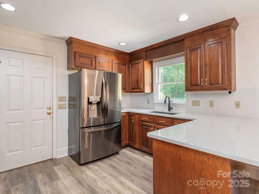 1231 Bennington Drive, Concord, NC 28027.  MLS# CAR4285344, YatesRealty ID 33260. KITCHEN WITH DOOR LEADING INTO GARAGE/STORAGE AREA