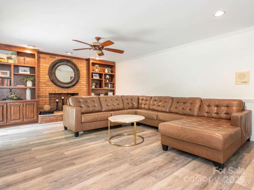 1231 Bennington Drive, Concord, NC 28027.  MLS# CAR4285344, YatesRealty ID 33260. LIVING ROOM WITH BUILT IN BOOKSHELVES, WOOD BURNING FP AND DOOR TO BACK DECK