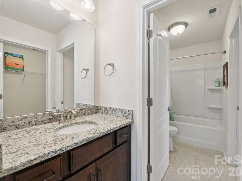 204 Hampton Trail Drive, Fort Mill, SC 29708.  MLS# CAR4350290, YatesRealty ID 33275. En-suite bathroom with granite counter & tile floors.
