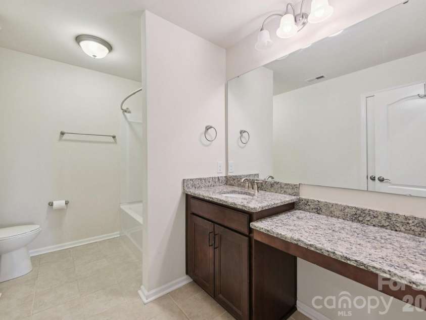 204 Hampton Trail Drive, Fort Mill, SC 29708.  MLS# CAR4350290, YatesRealty ID 33275. Ensuite bathroom with granite countertop, vanity area & tile flooring.