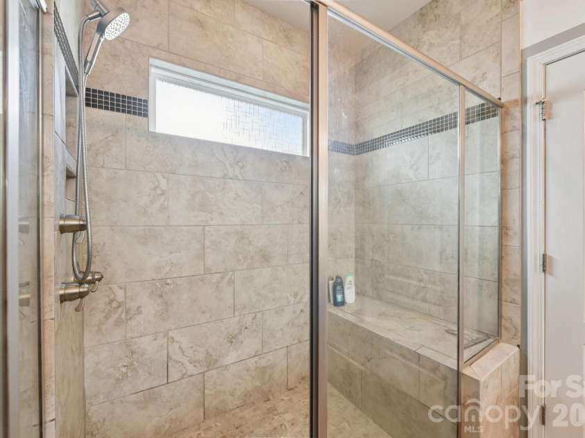 204 Hampton Trail Drive, Fort Mill, SC 29708.  MLS# CAR4350290, YatesRealty ID 33275. Large walk in shower in primary bathroom.
