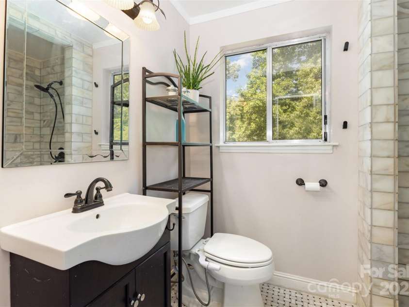 7015 Lavern Street, Charlotte, NC 28215.  MLS# CAR4260772, YatesRealty ID 33280. Primary Bathroom Walk-in Shower w Marble Surround