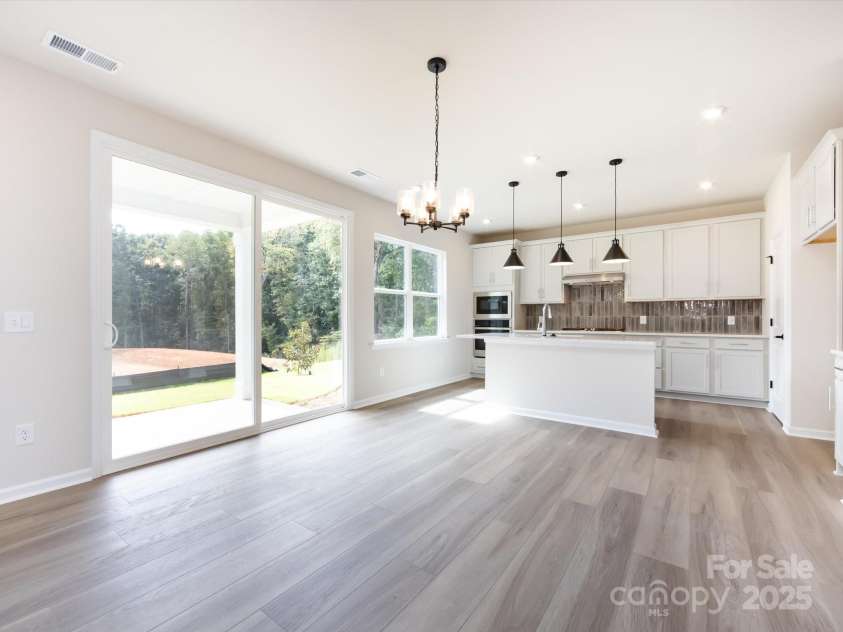 7023 Short Stirrup Lane, Mint Hill, NC 28227.  MLS# CAR4291701, YatesRealty ID 33286. Dining space highlighted by designer light fixture.