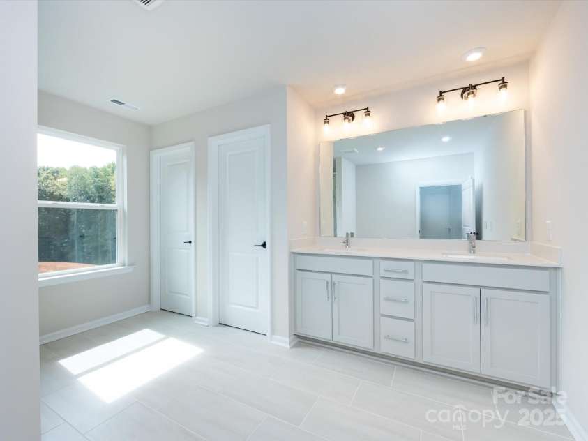 7023 Short Stirrup Lane, Mint Hill, NC 28227.  MLS# CAR4291701, YatesRealty ID 33286. Primary suite with dual vanity and loads of storage.